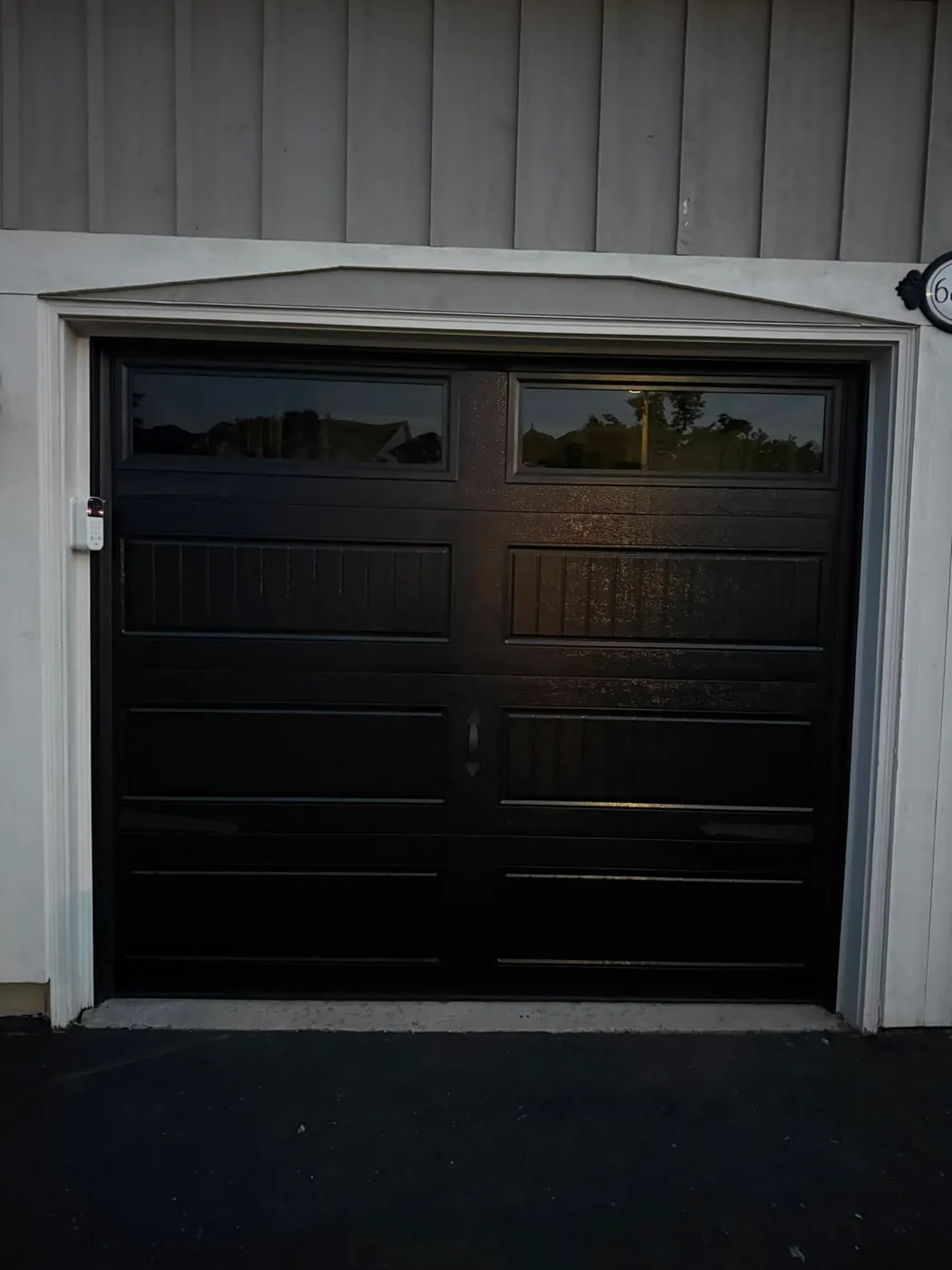 Black carriage-style single garage door with top windows — GTA