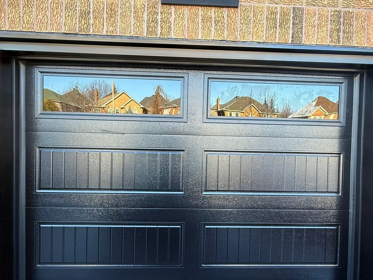 Black double flush-panel garage door with top windows — Vaughan