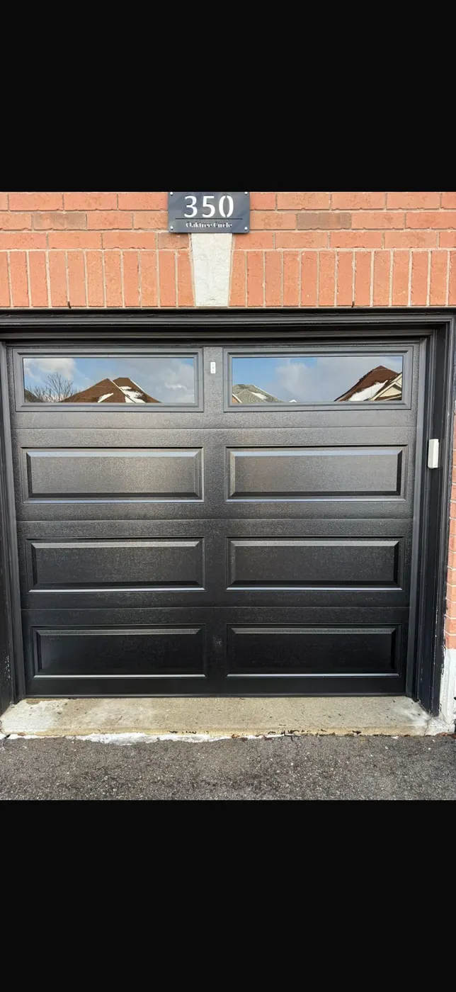 Black long-panel single garage door with clear top windows — GTA