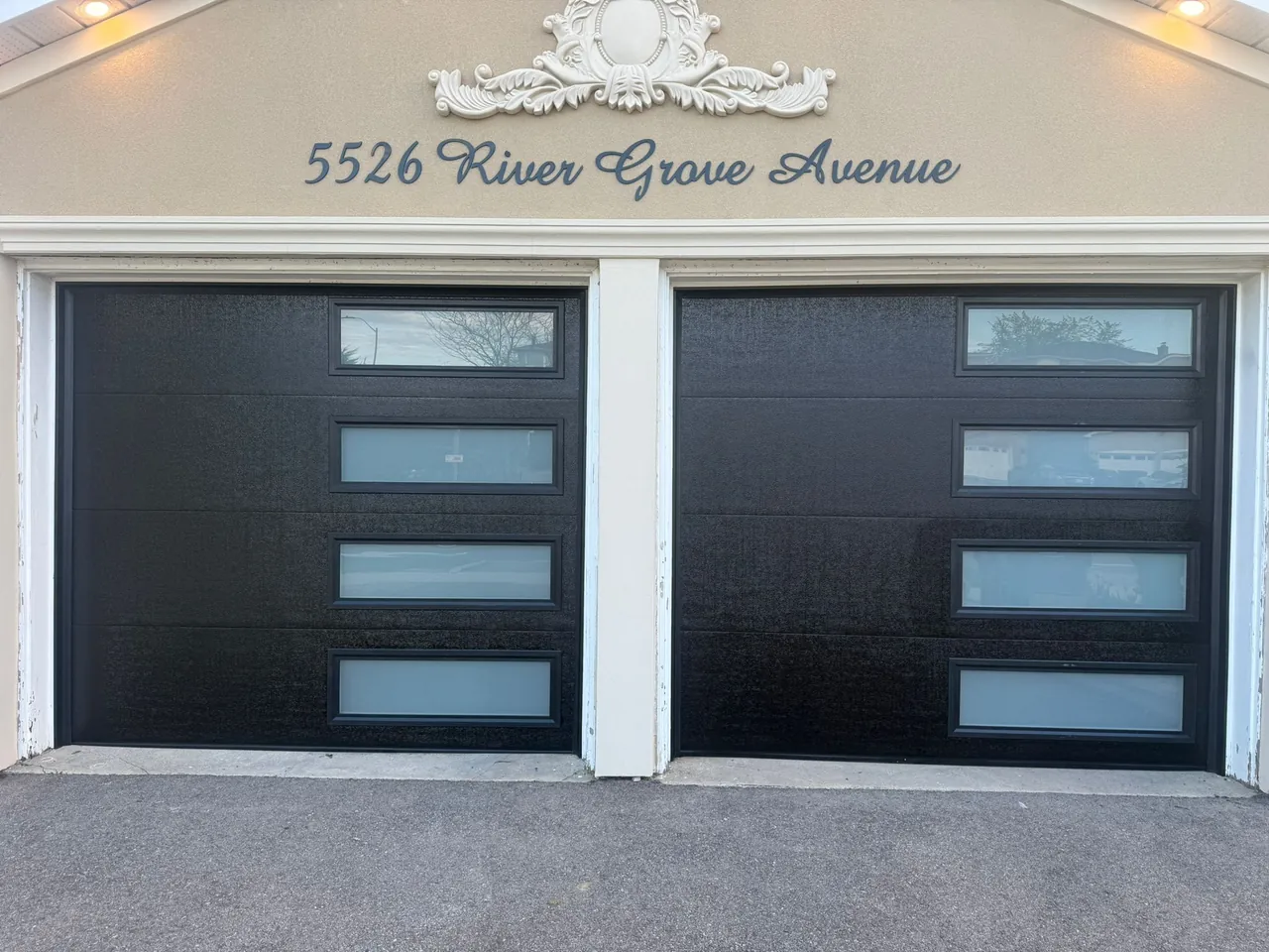 Black modern flush-panel double garage door with horizontal windows — GTA