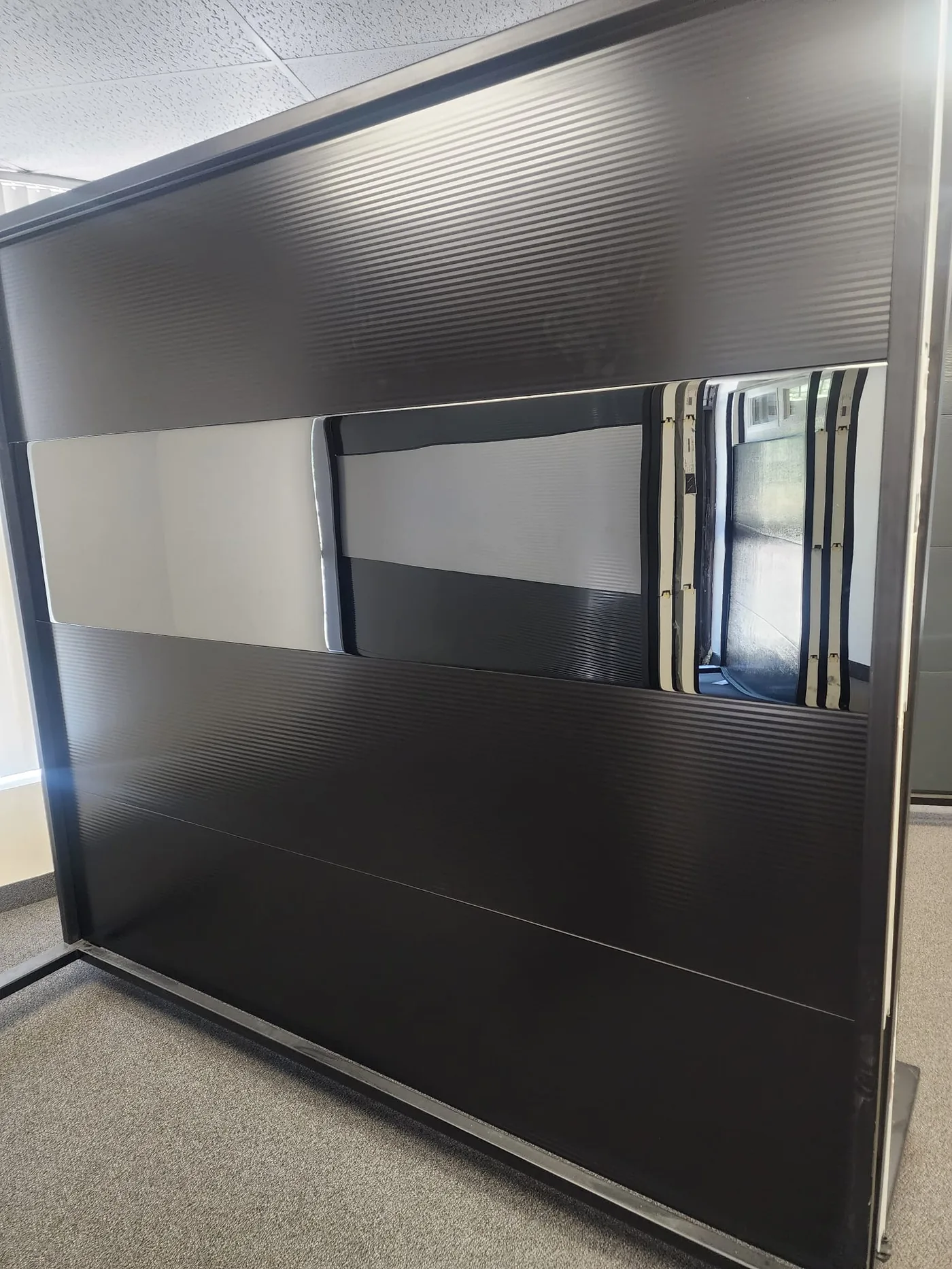 Black modern flush-panel garage door, detail view — GTA