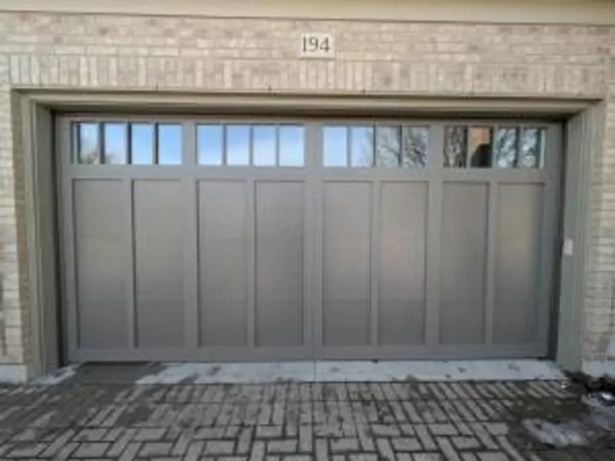 Black modern flush-panel garage door installation — Toronto