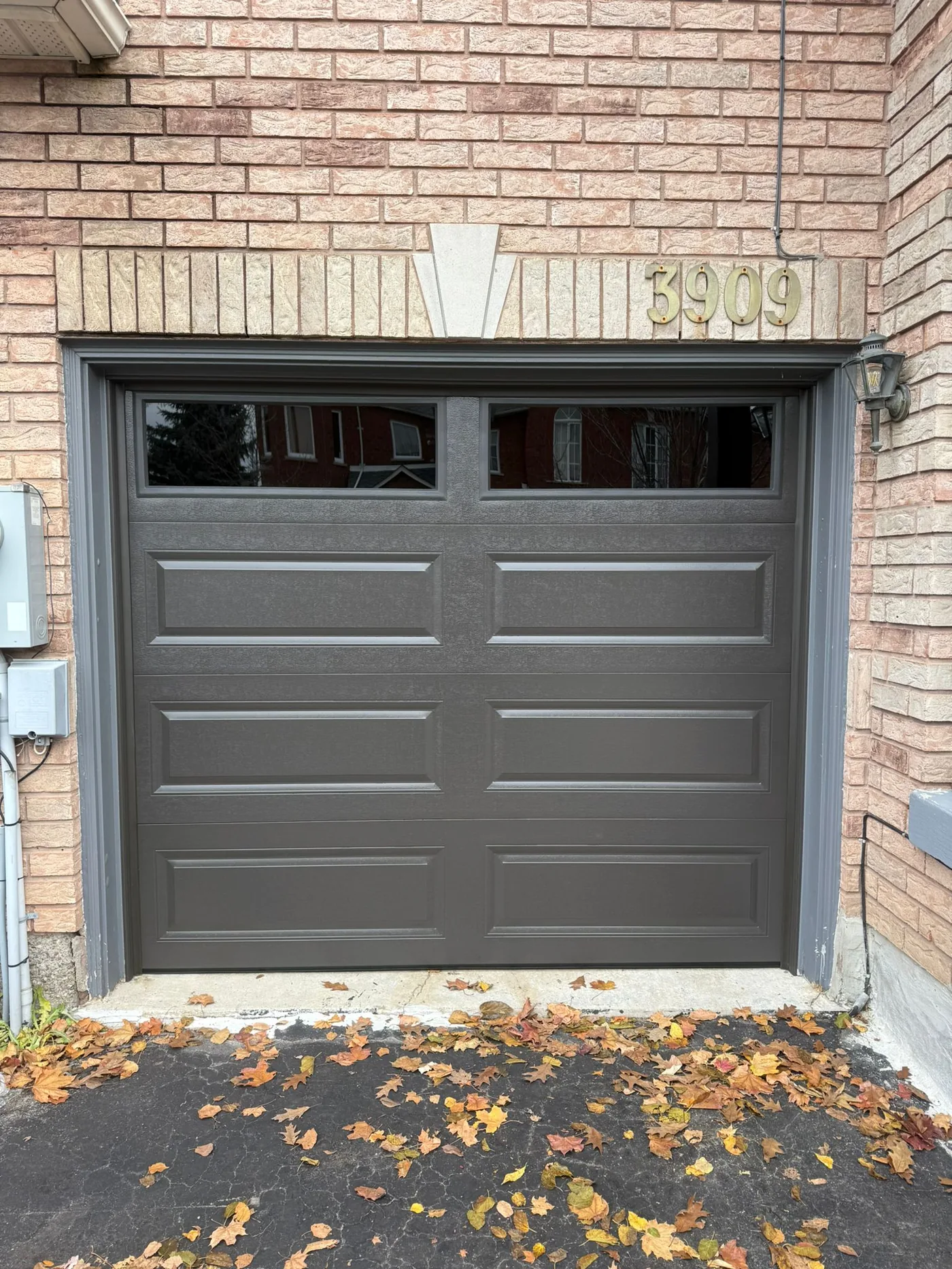Brown long-panel single garage door with top windows — GTA