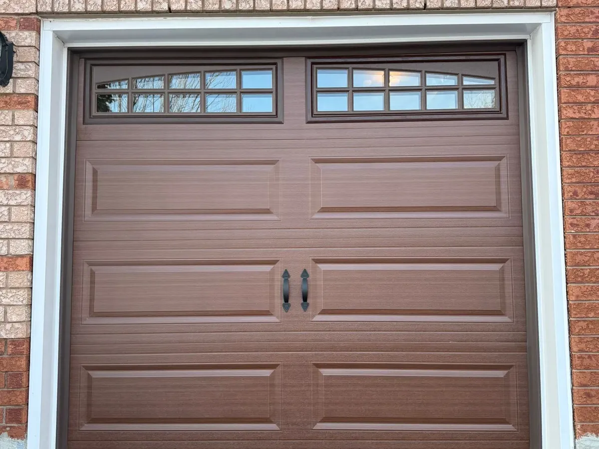 Brown woodgrain carriage garage door with arch windows — Toronto
