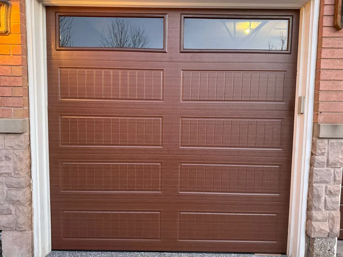 Cream sectional garage door with top windows — Vaughan