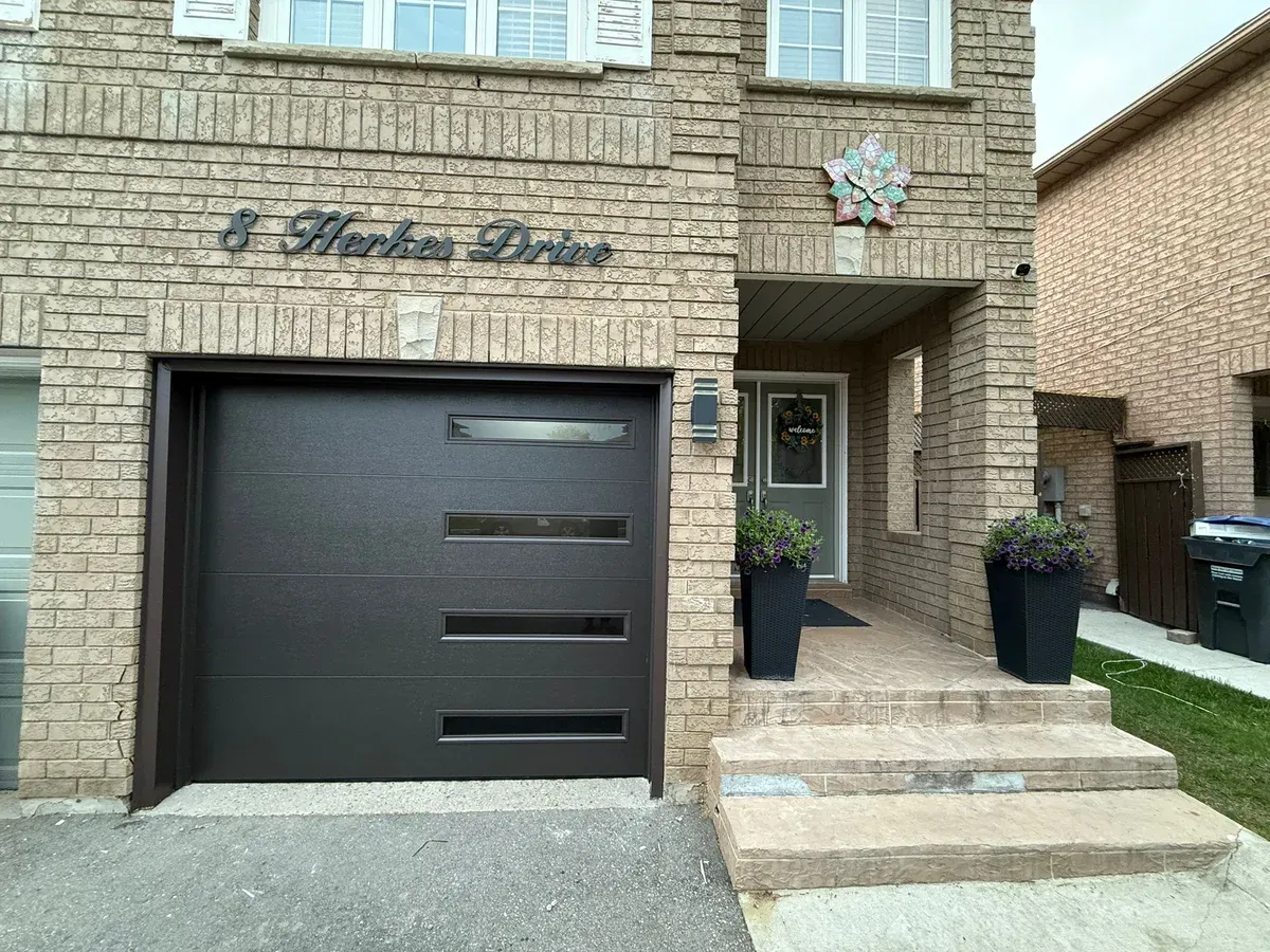 Dark charcoal modern garage door with horizontal glass — Mississauga