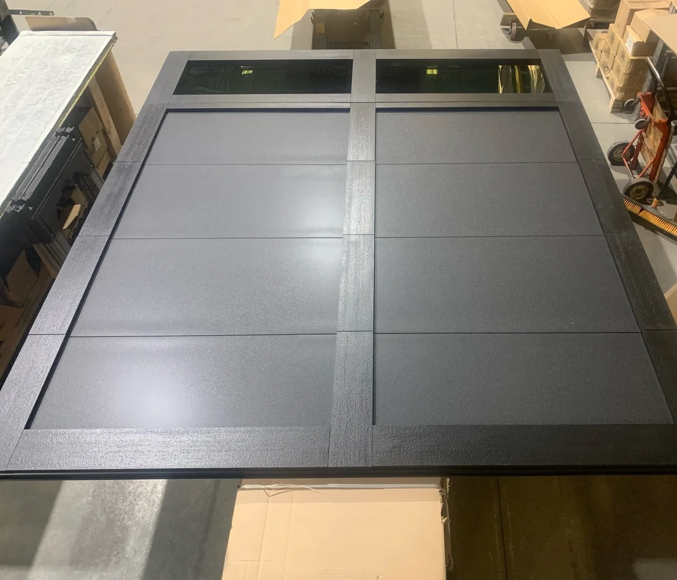 Dark grey carriage overlay garage door with grid panel trim — GTA