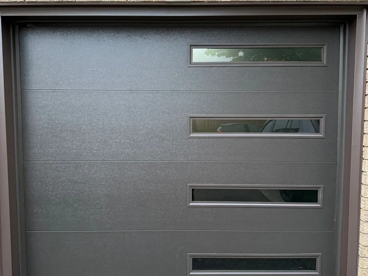 Dark grey modern garage door with side glass inserts — Toronto