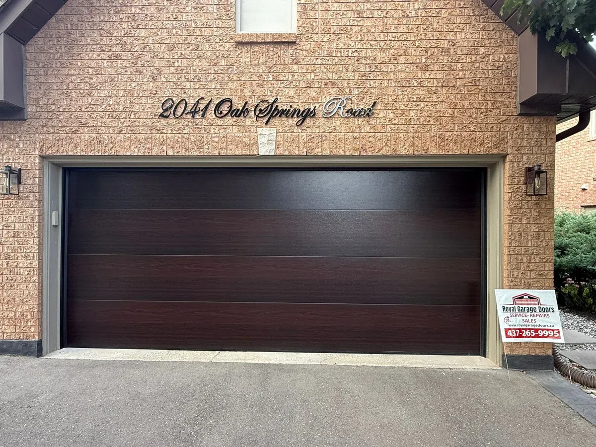 Dark walnut flush-panel double garage door — Oakville