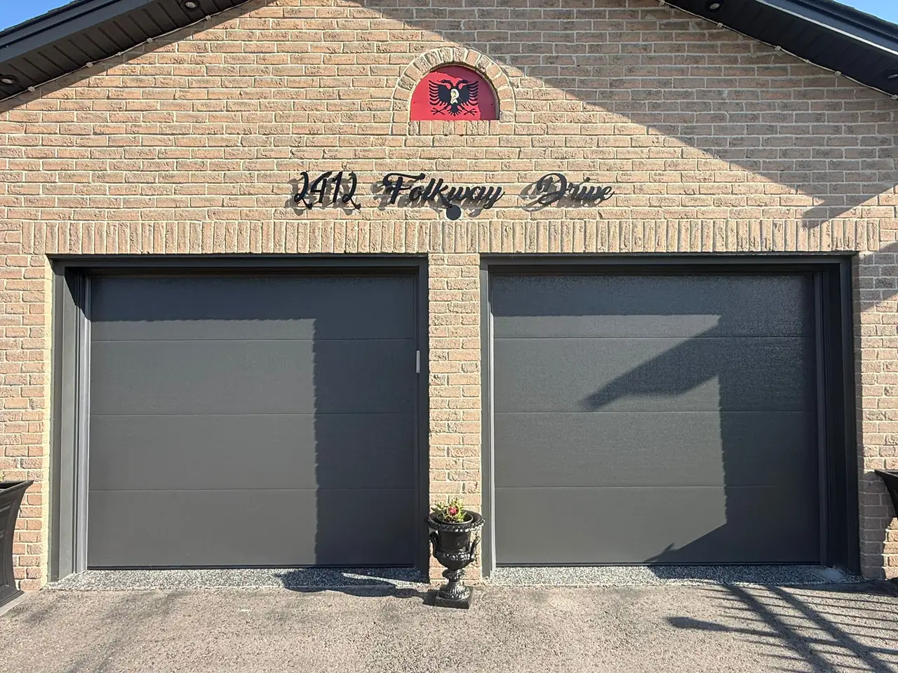 Graphite modern flush-panel double garage door close-up — GTA