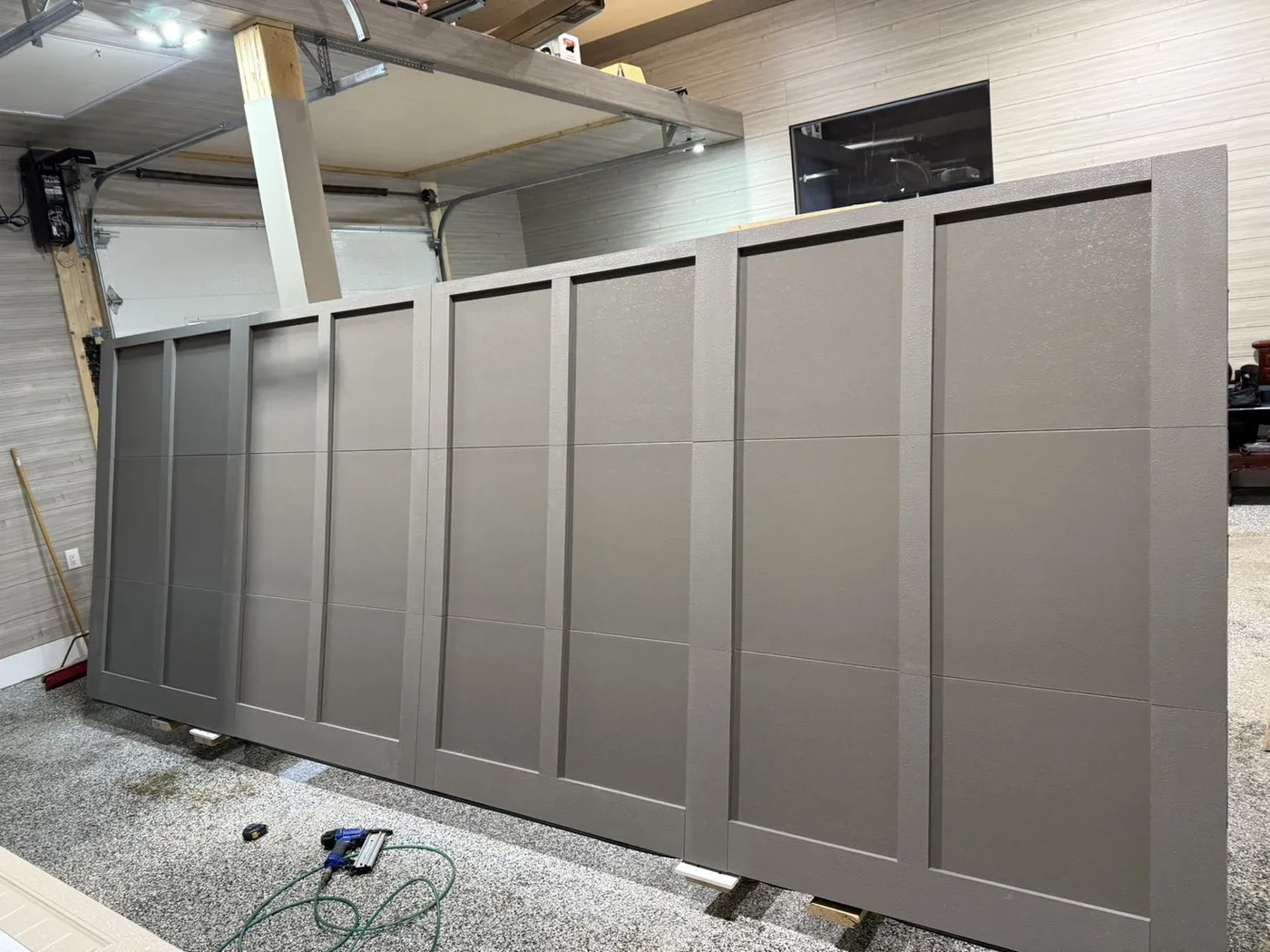 Grey carriage overlay garage door, installation in progress — GTA