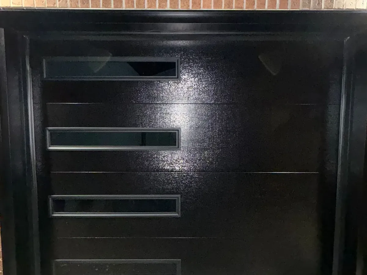 Modern steel garage door with horizontal glass — Toronto