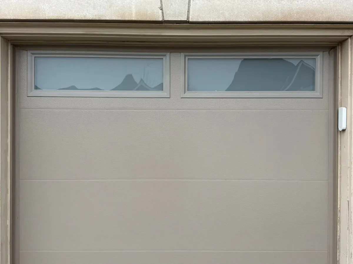 Steel sectional garage door with decorative windows — North York