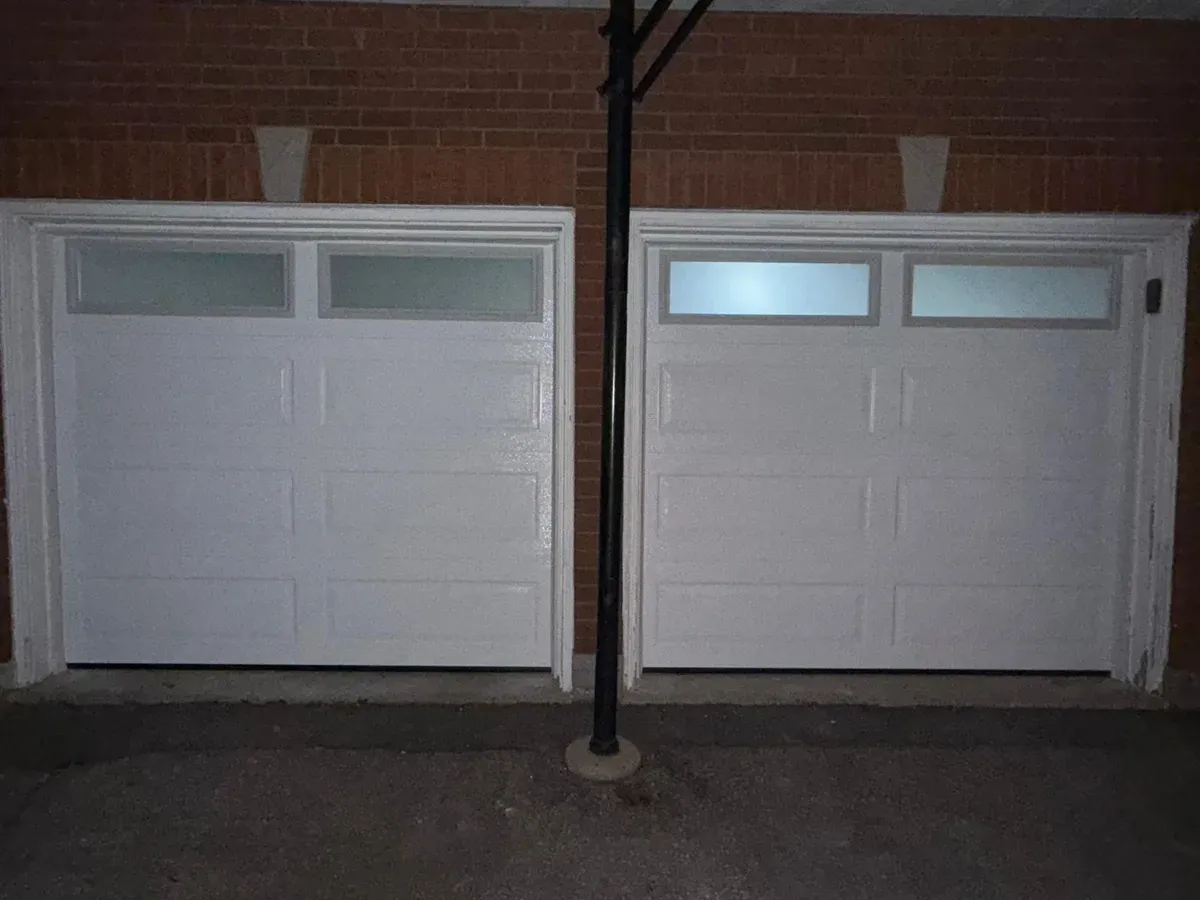 White double sectional garage door with frosted windows — Toronto